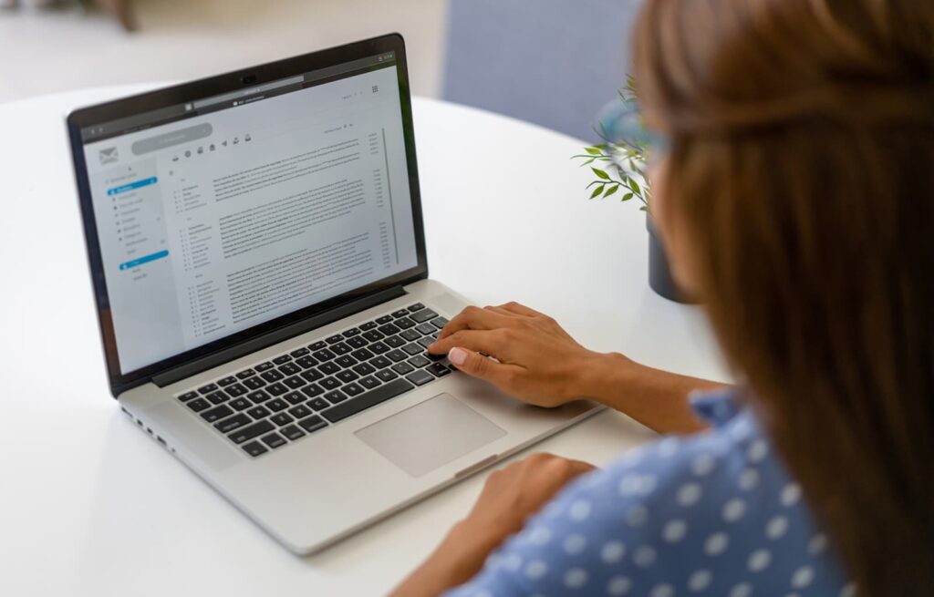 Person typing an outreach email on a laptop — link building email templates