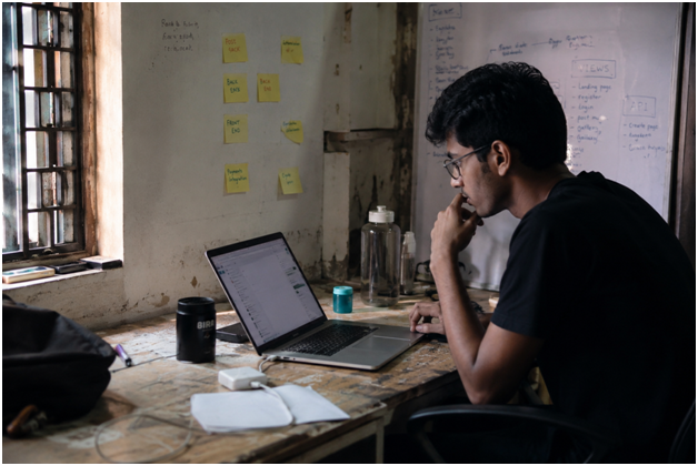 Founder working on a laptop at a desk on day one of launching a link building agency